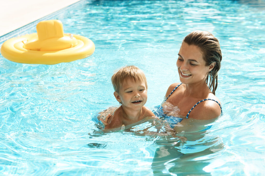 Mutter und Kind spielen im Pool.